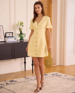 The Yellow V Neck Ruffle Button-up Mini Dress 9 The Yellow V Neck Ruffle Button-up Mini Dress -CINN Clothing Shop the yellow v neck ruffle mini dress dresses or6xts